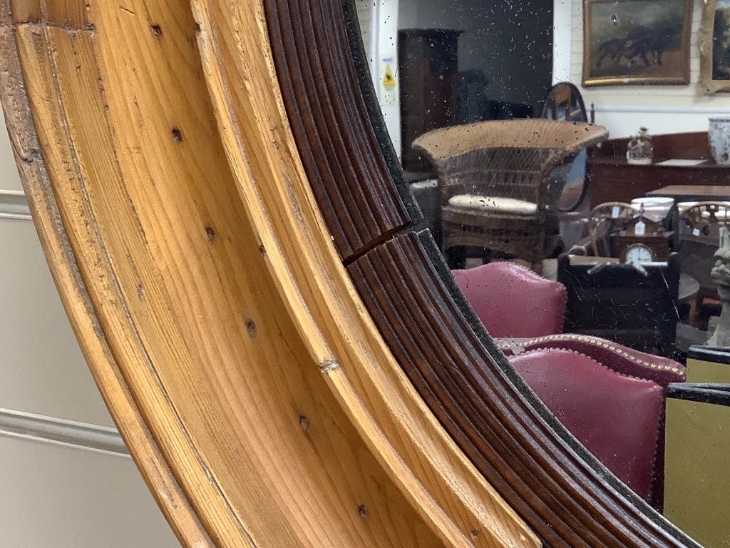 A 19th century circular pine framed mirror, diameter 68cm